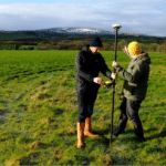 Macalpine and Flannery calibrating GPS device (Dartmoor in the background)